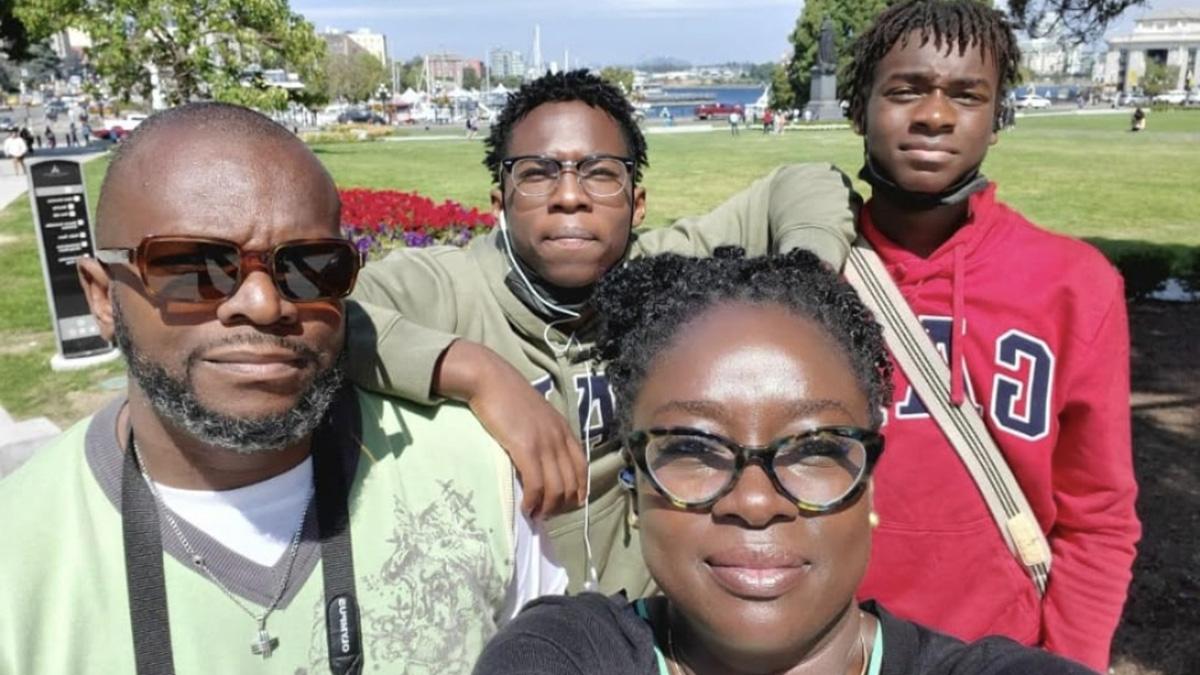 Shola with her husband and two sons.